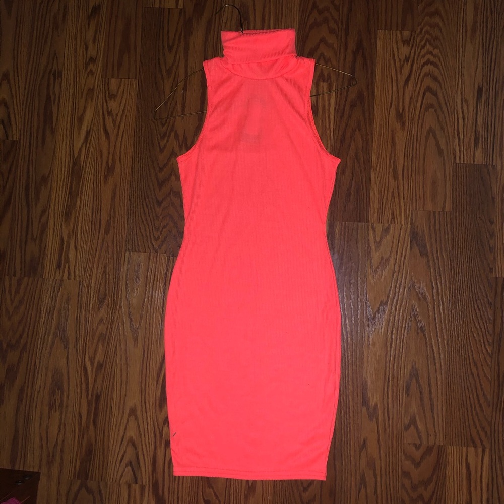 Neon orange bodycon turtleneck dress.